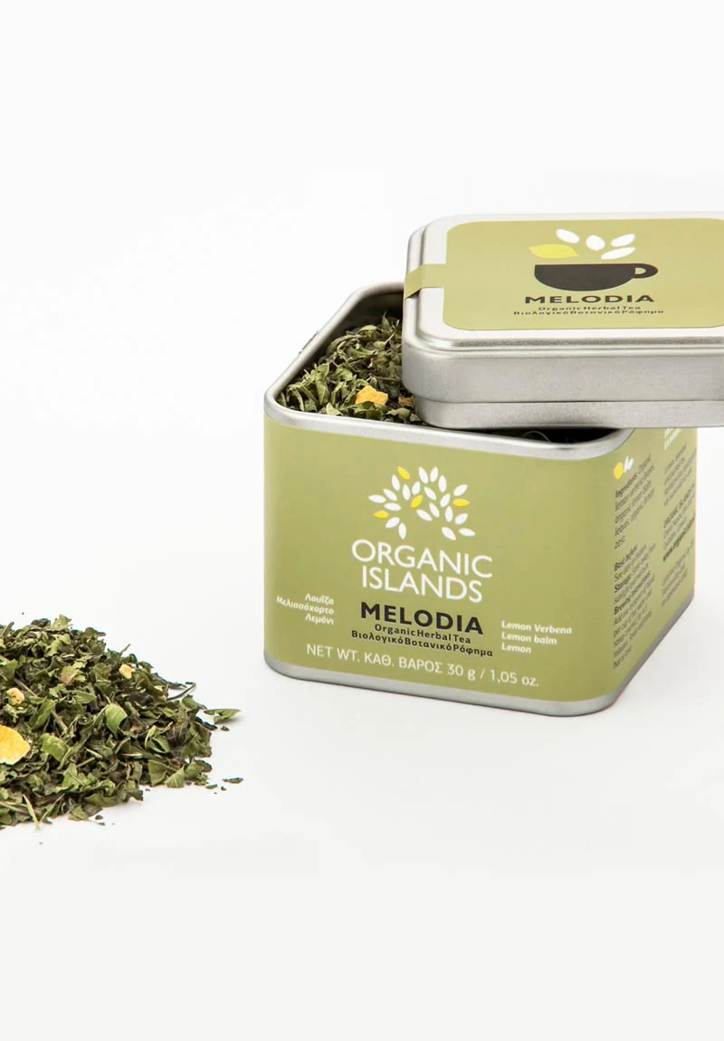Image of Organic Islands Melodia loose leaf tea in a container. The container is filled with a vibrant mix of dried lemon verbena leaves, lemon balm leaves, and lemon zest.
