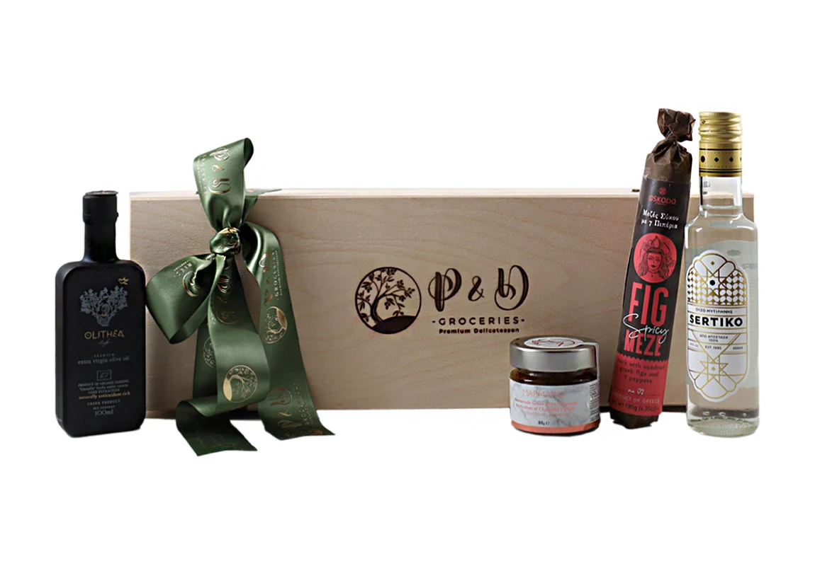 "Wooden gift box 'By the Sea' with olive oil, tapenade, fig roll, and ouzo. Elegant packaging with a metal clasp and satin ribbon."