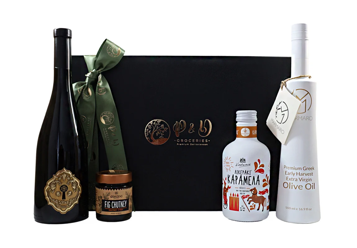 Luxurious black wooden gift box with premium Greek olive oil, caramel liqueur, fig chutney, and red wine – a tasteful ensemble for unforgettable moments.